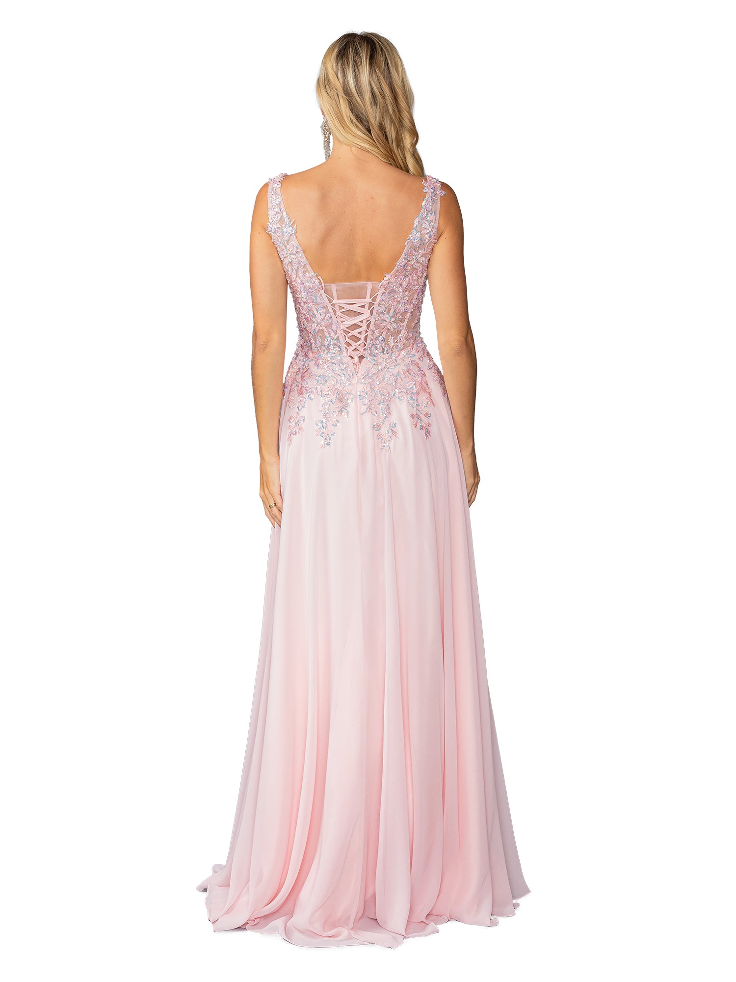 A woman faces away from the camera, wearing the Lace-Up Long A-Line Prom Dress: Dancing Queen 4446 in light pink, featuring lace detailing and a lace-up back.